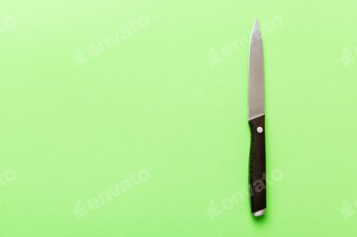Preview: A simple kitchen knife with wooden handle, top view isolated on green background