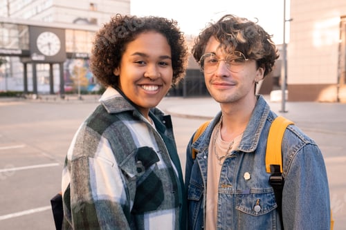 Preview: Happy mixed-race teenage girl and her Caucasian boyfriend in casualwear