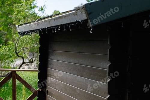 Preview: Wooden cabin exterior in Reykjavik Iceland surrounded by green trees and grass