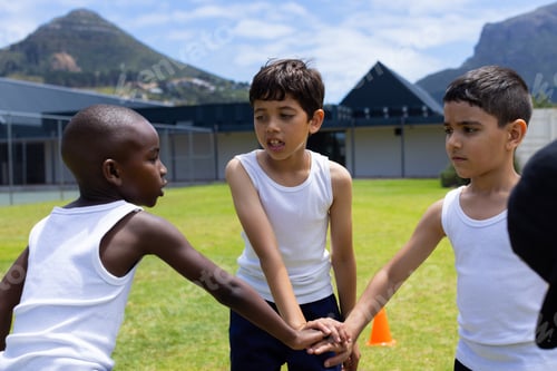Preview: Biracial and African American boys join hands in a game outdoors in school