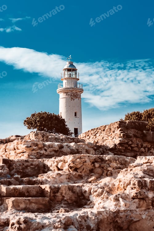 Preview: Scenic landscape with lighthouse and blue sky. Vertical image
