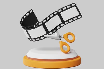 Preview: Scissors cutting film strip on pedestal.