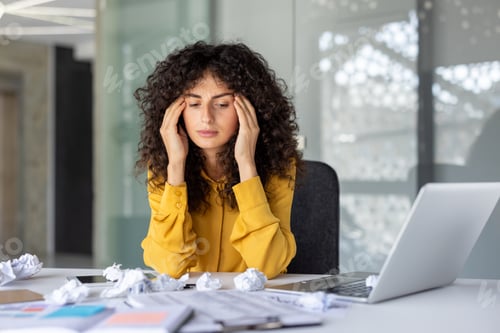 Preview: Stressed businesswoman overwhelmed by paperwork in modern office environment