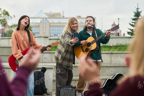 Preview: Multiethnic Young Adults Performing Live Music Outdoors While Taking Selfie