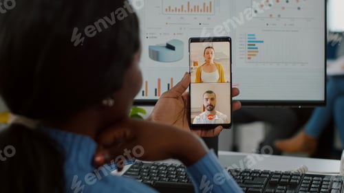 Preview: Handicapped invalid african manager talking on videocall with friends
