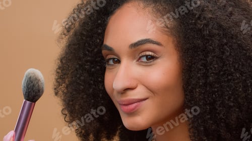 Preview: Close up portrait beige studio background beautiful African American woman with perfect skin blow to