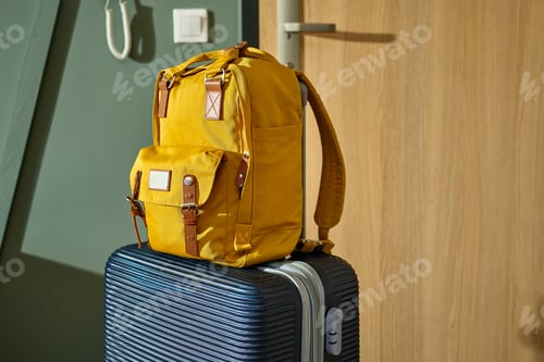 Preview: Yellow Backpack on Suitcase by Door, Luggage Ready For Trip