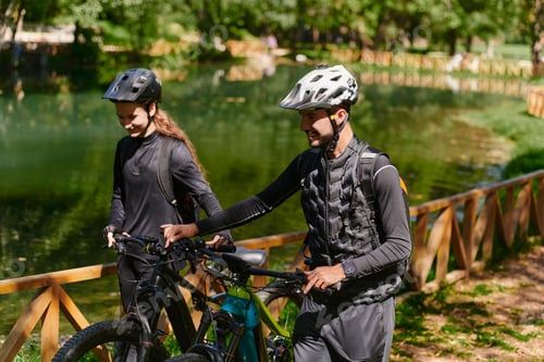 Preview: A blissful couple, adorned in professional cycling gear, enjoys a romantic bicycle ride through a