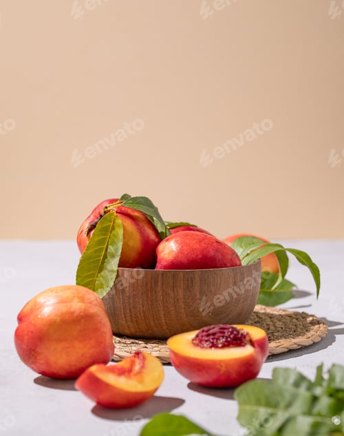 Preview: Juicy and sweet nectarines in a bowl on a light background with shadow. Healthy organic farm fruit