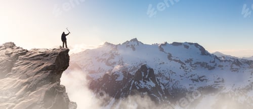 Preview: Adventure Man on top of Rocky Mountain Cliff. Aerial Canadian Mountain landscape from BC, Canada.