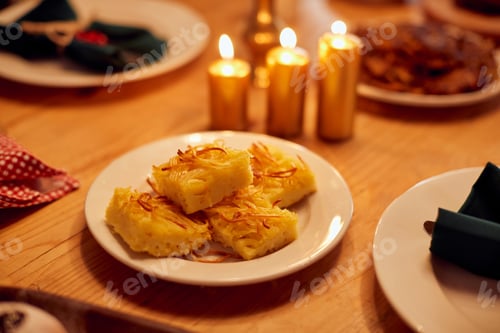 Preview: Traditional noodle kugel on dining table during Hanukkah celebration.
