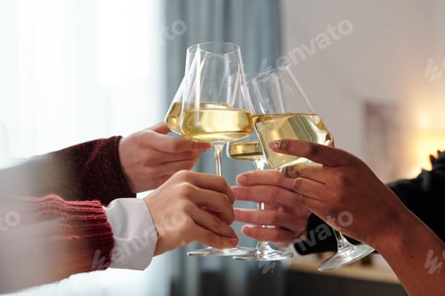 Preview: Hands of young friends or business people clinking with flutes of champagne