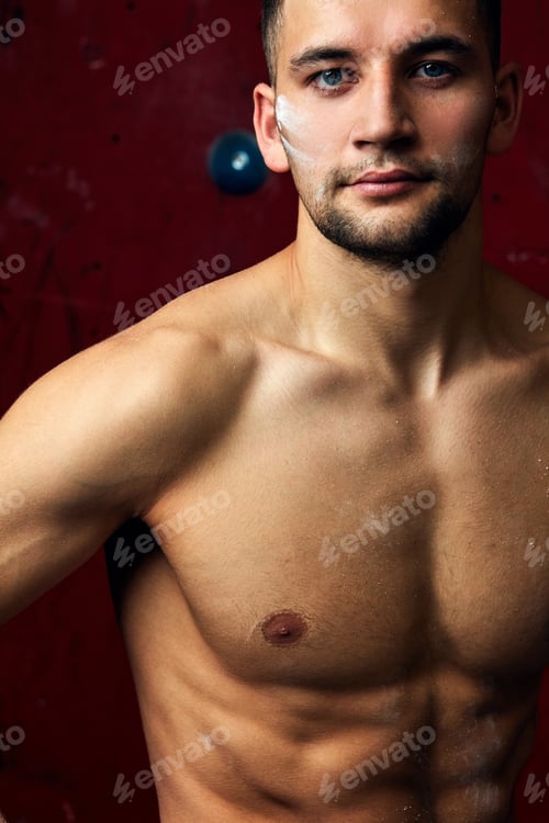 Preview: Closeup portrait of rock climber against artificial wall for climbing