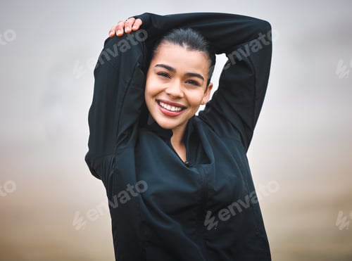 Preview: Cropped portrait of an attractive young female athlete warming up outside