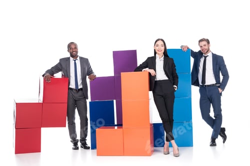 Preview: smiling multiethnic business people with colorful blocks isolated on white, teamwork concept