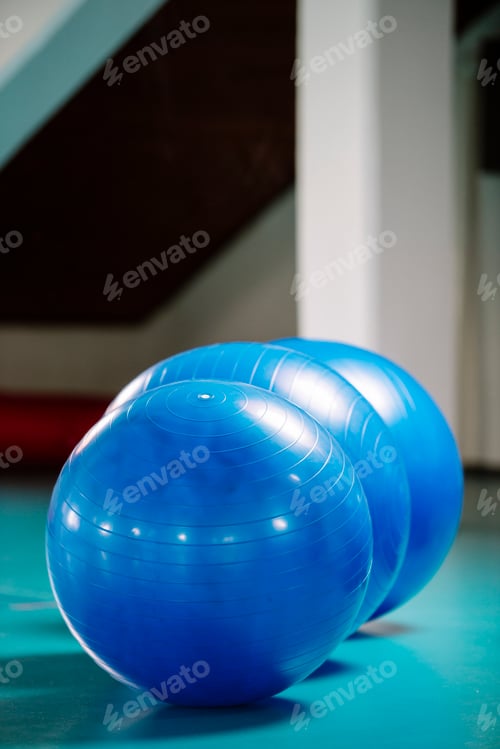 Preview: Group of blue pilates balls in the gym