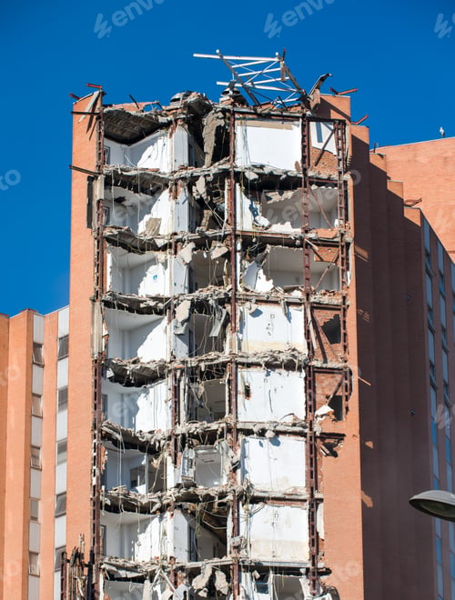 Preview: An excavator amidst a dusty demolition site