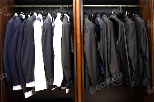 Preview: Many men's suits on a hanger in the store