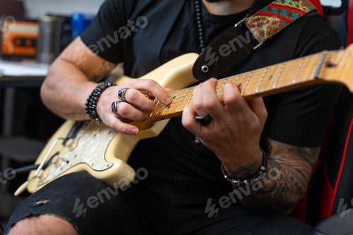 Preview: Hipster guitarist rehearsing in his studio.