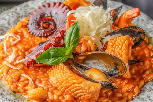 Preview: Delicious Italian risotto served with octopus tentacle, mussels, squid, shrimp