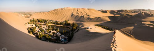 Preview: Tourists climbing sand dunes at sunset at Huacachina, a village in the desert, Ica Region, Peru, Sou