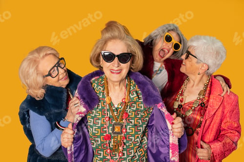 Preview: Four stylish senior women showing fashion and happiness on yellow background