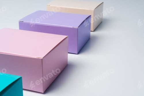 Preview: Pile of colorful cardboard boxes on white background