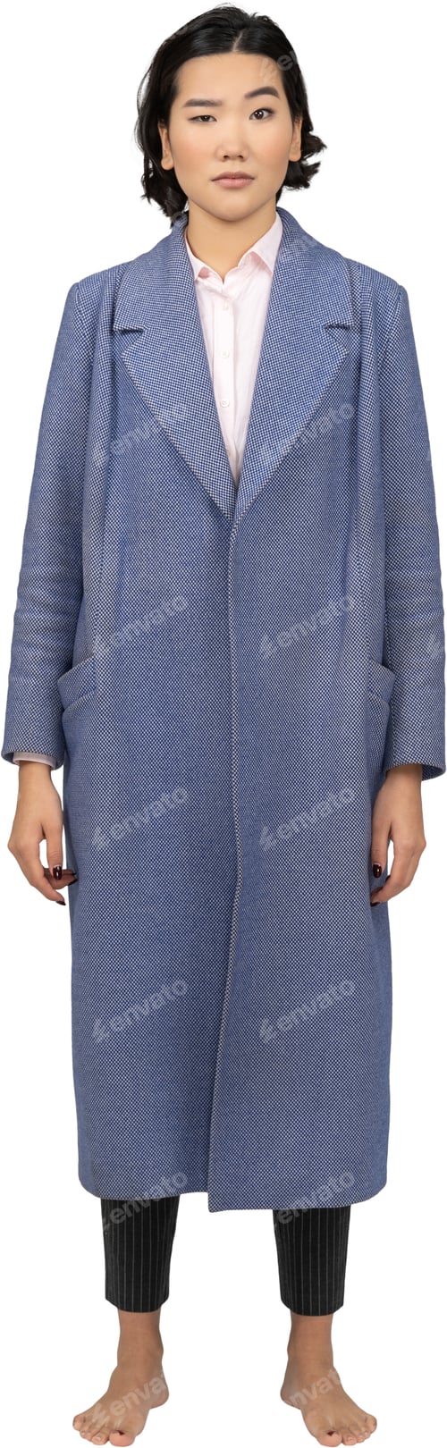 Preview: a woman wearing a blue coat and a white dress and heels