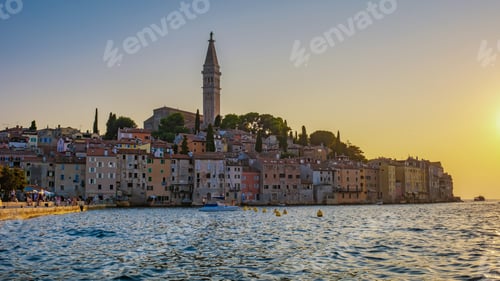 Preview: Breathtaking sunset over the picturesque harbor of Rovinj, Croatia with charming pastel buildings