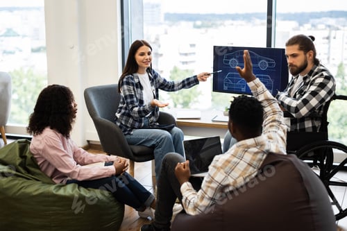 Preview: Team discussing automotive design project in modern workspace environment