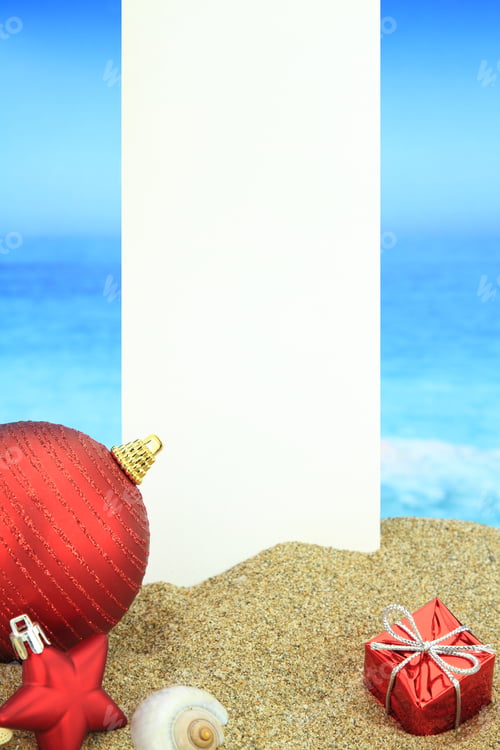 Preview: White banner and Christmas ornaments on the beach
