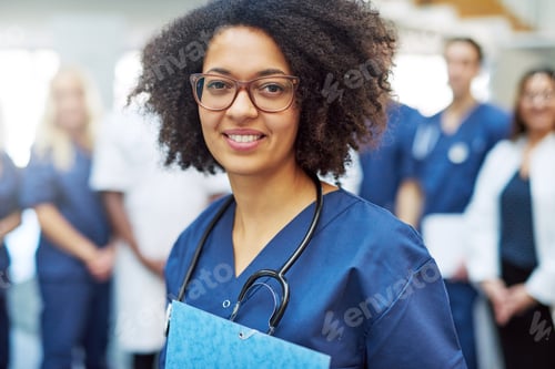 Preview: Smiling woman in medical uniform in hospital
