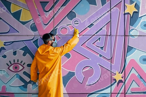 Preview: Street artist painting colorful graffiti on wall