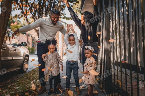 Preview: Family Having Fun Throwing Autumn Leaves