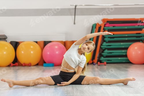 Preview: Young girl doing side stretch in split