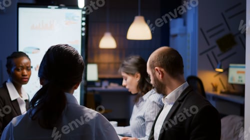 Preview: Selective focus workaholics focused multi-ethnic businesspeople overworking in company office
