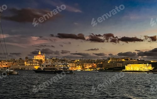 Preview: Beautiful sunset at Sliema embankment, Malta with the view on light city