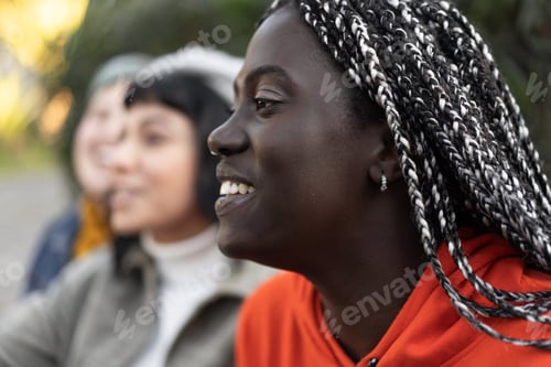 Preview: Joyful Moment - Radiant African Woman with Braids Laughing with friends