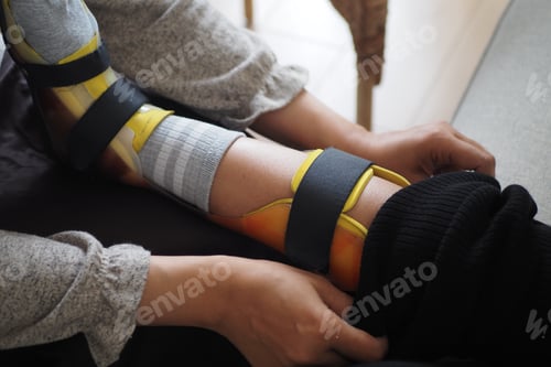 Preview: A mother adjusts a leg brace on her child .