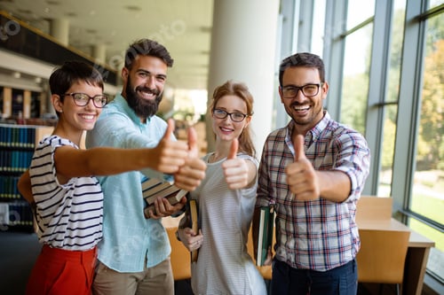 Preview: Happy university students studying with books in library. Group of multiracial people in college