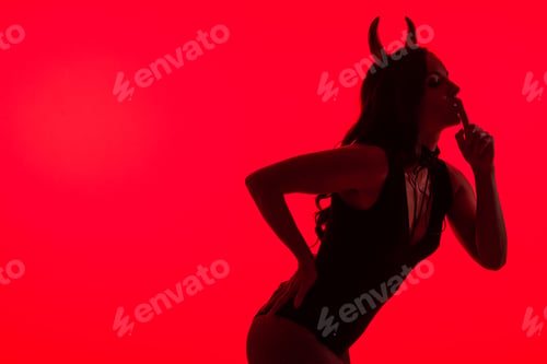 Preview: silhouette of sexy woman in Devil costume showing silence symbol, isolated on red