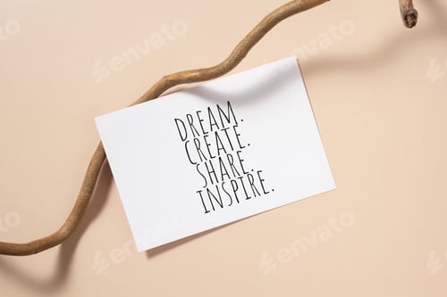 Preview: Dream, create, share, inspire words written on card. Invitation card on beige background.