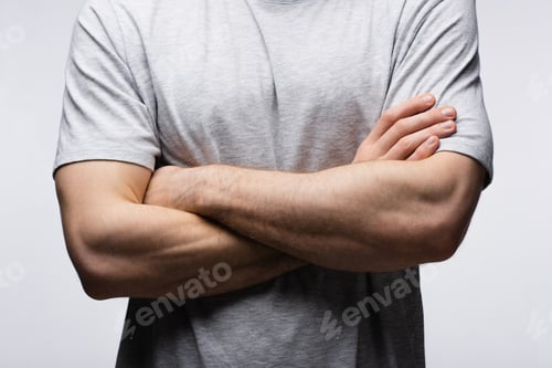 Preview: cropped view of man standing with crossed arms isolated on grey, human emotion and expression