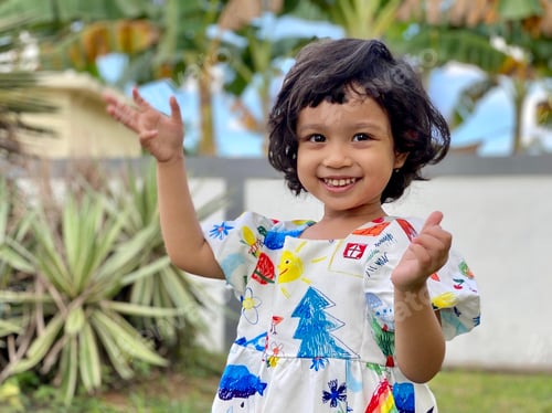 Preview: Kid smiling standing in the garden