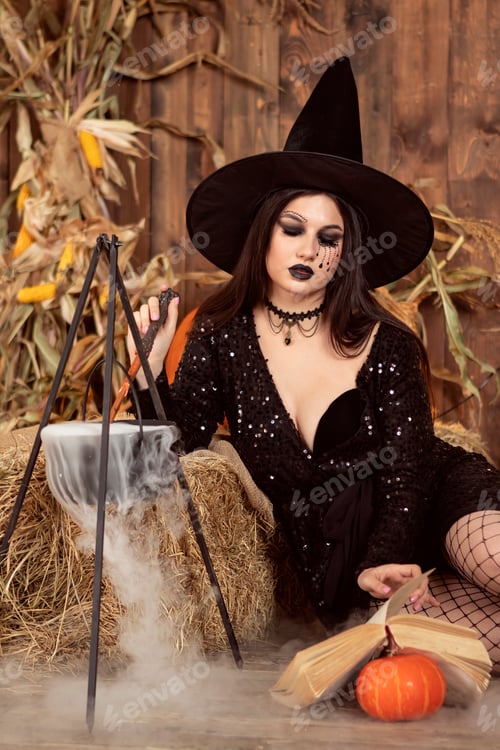 Preview: young girl in the image of a witch, wearing a black hat and a black dress with a make-up