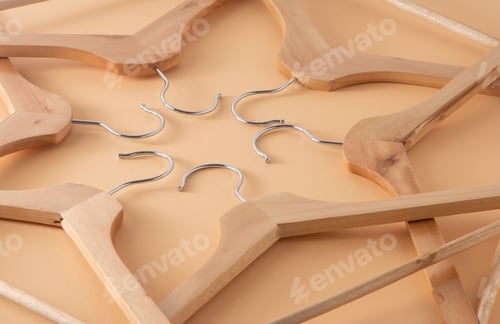 Preview: Hangers for clothes. Hanger set. Beige background. Wooden hangers. Store shop