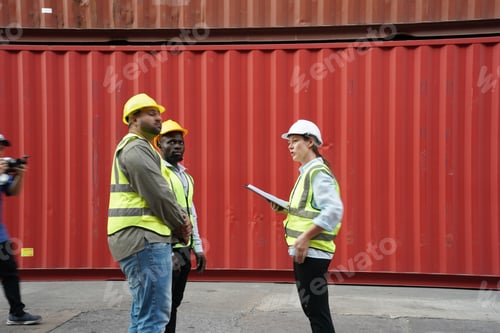 Preview: Foreman control loading Containers box from Cargo freight ship for import export.