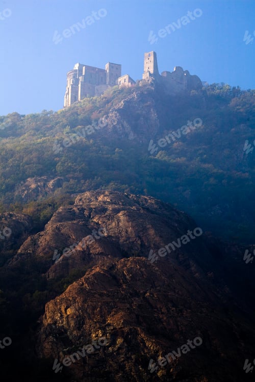 Preview: An ancient fortress stands atop a rugged hill under a clear blue sky