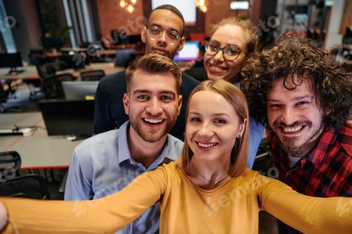Preview: A diverse group of business professionals take a break from their tasks in a modern startup office