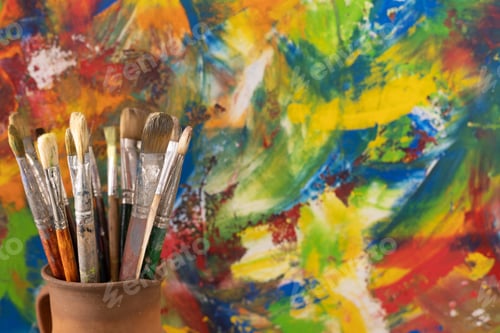 Preview: Paint brush in clay jug and oil painting background texture. Paintbrush painting and art still life